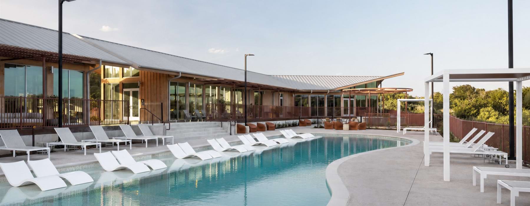 Swimming pool with white loungers. 